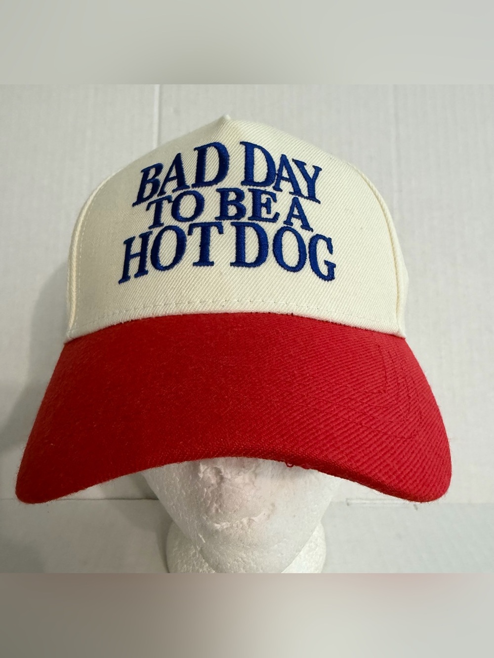 “Bad Day to Be a Hot Dog” Cream and Red Trucker Hat with Blue Embroidered Slogan